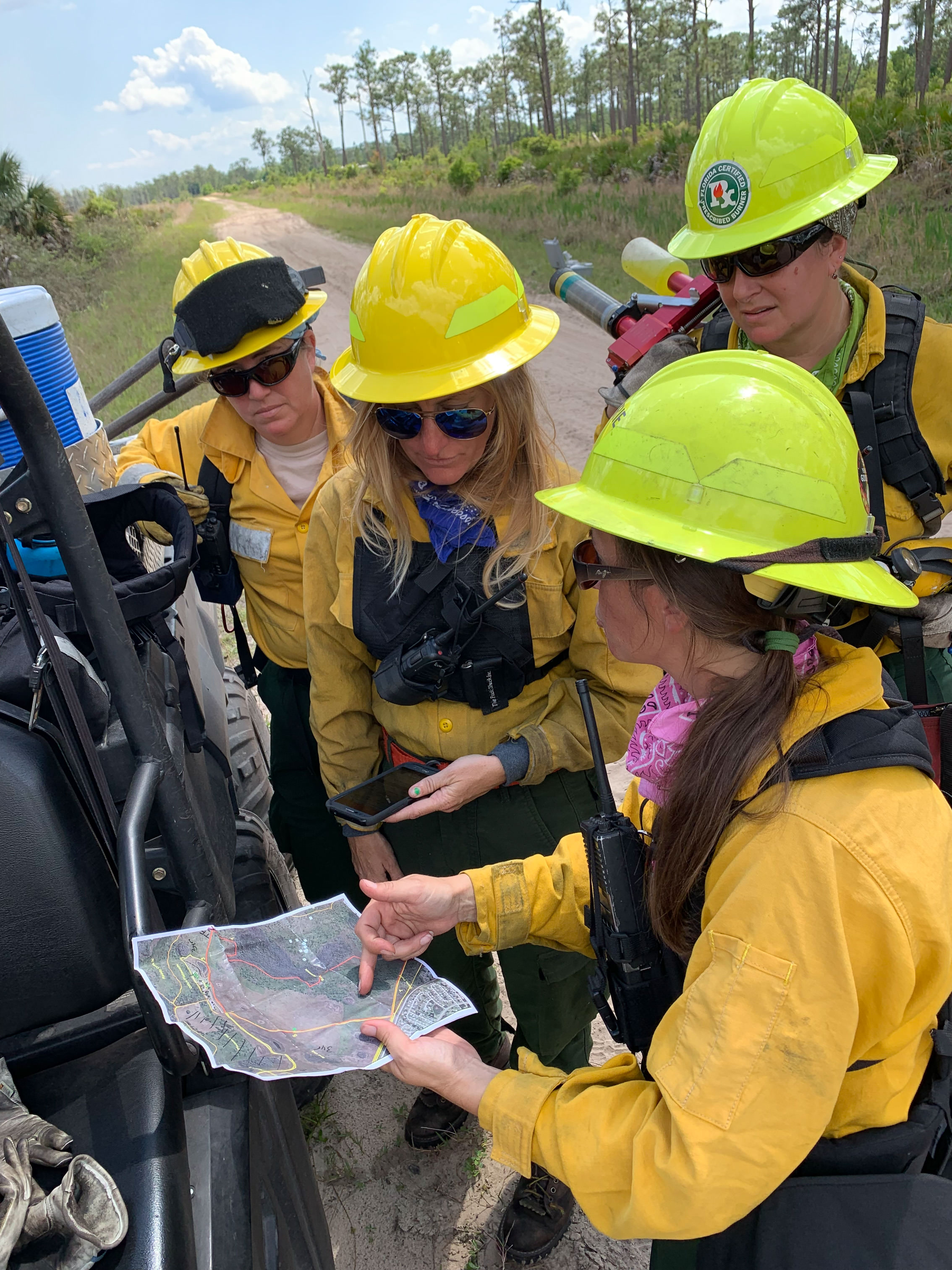 Four women wildland firefighters in the field.